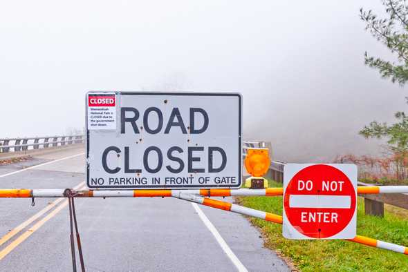 Image Road Closed sign blocking highway